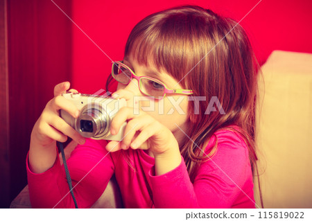 Little toddler girl playing with camera Little toddler girl playing with camera 115819022