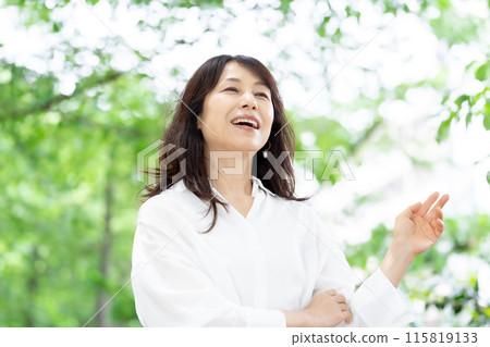 Woman stretching, fresh greenery Woman stretching, fresh greenery 115819133