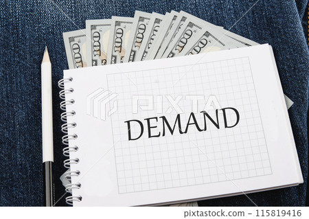 Business concept. A Word DEMAND on a checkered notebook in a composition with dollars bills and a pencil Business concept. A Word DEMAND on a checkered notebook in a composition with dollars bills and a pencil 115819416