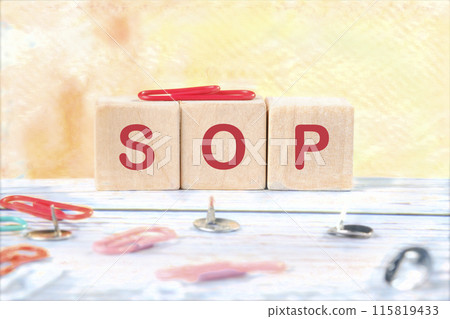 SOP - Standard Operating Procedure, text on wooden cubes on a yellow background 115819433