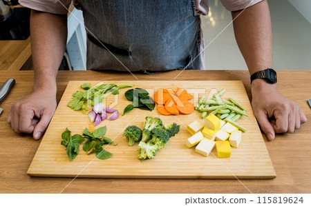 Chef at the kitchen preparing green curry with herbs and rice Chef at the kitchen preparing green curry with herbs and rice 115819624