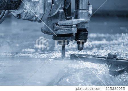 Close-up scene of multi-axis abrasive waterjet cutting machine cutting the aluminum plate. Close-up scene of multi-axis abrasive waterjet cutting machine cutting the aluminum plate. 115820055