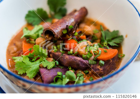 A vegetarian massaman curry in a bowl with sweet potato and many spices A vegetarian massaman curry in a bowl with sweet potato and many spices 115820146