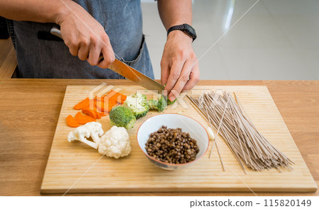 Chef at the kitchen preparing japanese buckwheat pasta with lentils Chef at the kitchen preparing japanese buckwheat pasta with lentils 115820149
