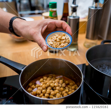 Chef at the kitchen preparing massaman curry with sweet potato and many spices 115820161