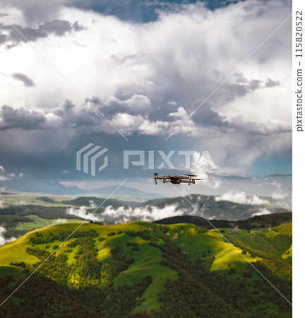 Drone flying in mountains and forest with green trees and clouds in summer 115820522