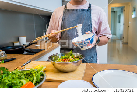 Chef at the kitchen preparing spicy glass noodle salad 115820721
