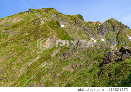 The Nishikuro Ridge of Japan's famous peak, Mt. Tanigawa, and climbers walking along the rocky terrain 115821275