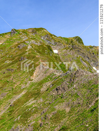 The Nishikuro Ridge of Japan's famous peak, Mt. Tanigawa, and climbers walking along the rocky terrain 115821276