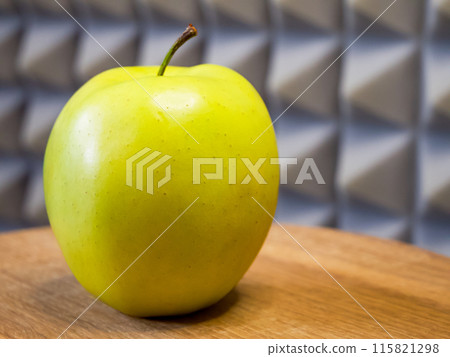 Apple on wooden texture, reflects organic quality, useful for eco-friendly product branding. 115821298