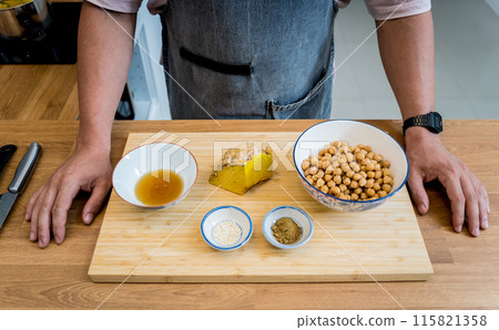Chef at the kitchen preparing chickpea porridge with ginger Chef at the kitchen preparing chickpea porridge with ginger 115821358