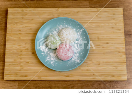 Different color delicious Japanese mochi on the blue plate 115821364