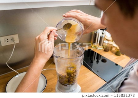 Chef at the kitchen preparing chickpea porridge with ginger Chef at the kitchen preparing chickpea porridge with ginger 115821378