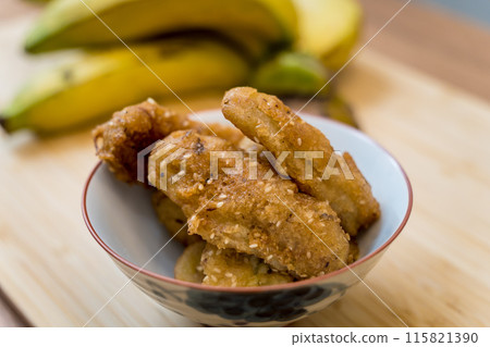 Crispy fried bananas in the small white bowl Crispy fried bananas in the small white bowl 115821390