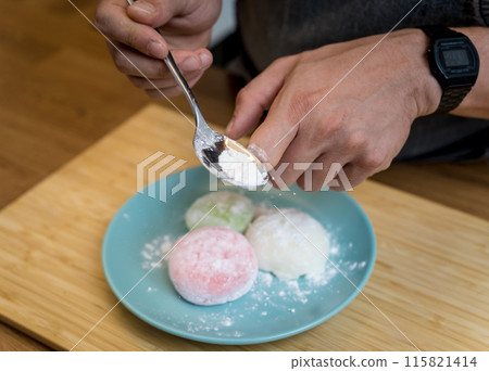 Different color delicious Japanese mochi on the blue plate Different color delicious Japanese mochi on the blue plate 115821414