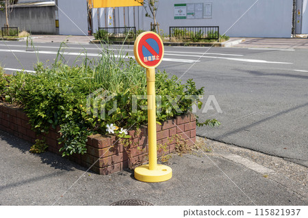 A pole sign on the sidewalk saying "No Parking" 115821937