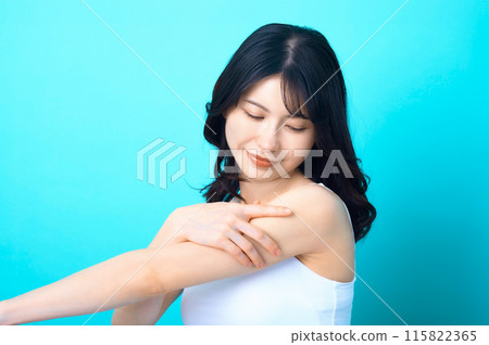 Beauty image of a woman posing in front of a blue background Beauty image of a woman posing in front of a blue background 115822365