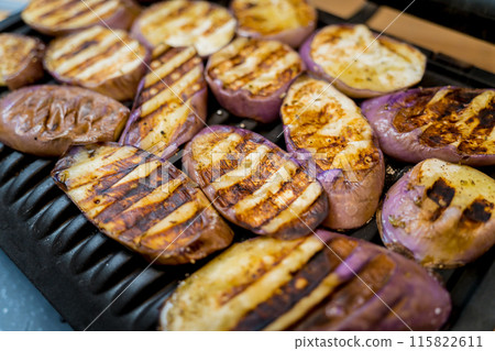 Delicious grilled eggplants with garlic on the electric grill Delicious grilled eggplants with garlic on the electric grill 115822611