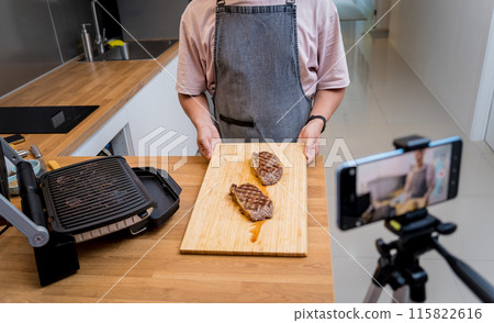 The chef is broadcasting live from workshop how to prepare a beef steaks on the electric grill The chef is broadcasting live from workshop how to prepare a beef steaks on the electric grill 115822616