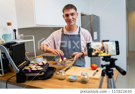 The chef is broadcasting live from workshop how to prepare a grilled eggplants with garlic 115822630