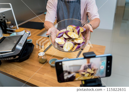 The chef is broadcasting live from workshop how to prepare a grilled eggplants with garlic 115822631