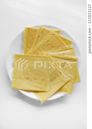 Melted cheese in flat slices. Processed cream cheese for sandwiches. 115823227