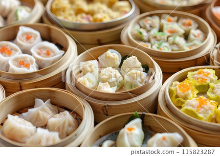 A delicious array of various Chinese dumplings presented in bamboo steamers, showcasing an appetizing selection of fillings and textures.. A delicious array of various Chinese dumplings presented in bamboo steamers, showcasing an appetizing selection of fillings and textures.. 115823287