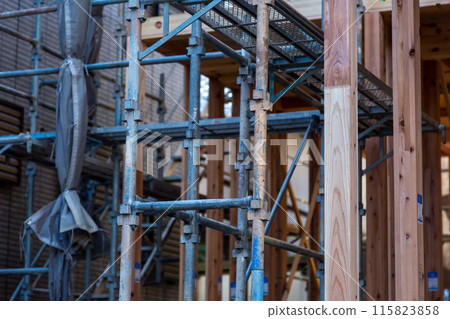 New construction site, wooden two-story house under construction 115823858