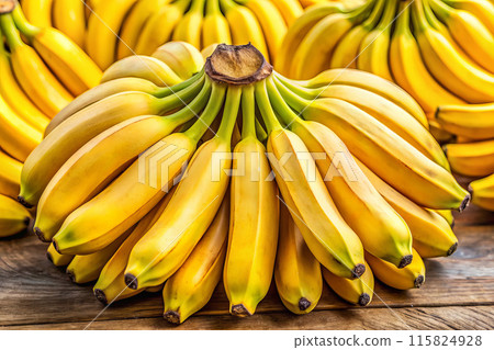 Bananas on a table, displaying their beauty and yellow color 115824928