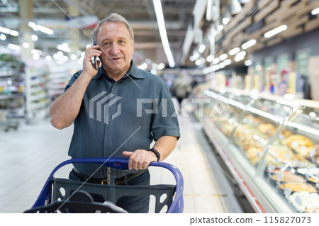Elderly man walks through a supermarket Elderly man walks through a supermarket 115827073