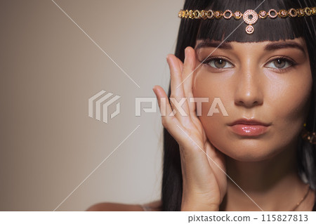 Close-Up Portrait of Woman with Cleopatra-Inspired Makeup and Tan Skin Close-Up Portrait of Woman with Cleopatra-Inspired Makeup and Tan Skin 115827813