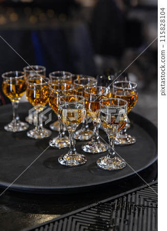 Elegant glasses of amber liquor 115828104