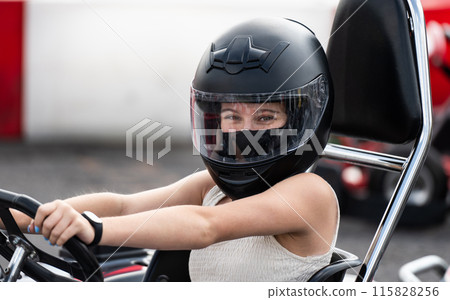 Portrait Of Young Girl In Protective Helmet In Go-Kart On A Track 115828256