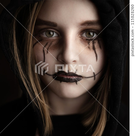 Little girl with spooky Halloween makeup looking at camera closeup portrait. Creepy child's portrait. Little girl with spooky Halloween makeup looking at camera closeup portrait. Creepy child's portrait. 115828260