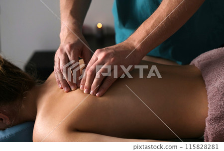 Massage Therapist Massaging Back Of Young Girl In A Massage Spa Salon, Procedures For Health Spine And Back Muscles 115828281