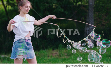 Girl Blows Large Soap Bubbles, Outdoor Fun Girl Blows Large Soap Bubbles, Outdoor Fun 115828307
