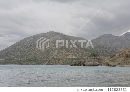 Mountain and seascape. Rocky seashore in cloudy weather Mountain and seascape. Rocky seashore in cloudy weather 115828581