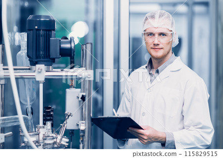 Scientist Medical Factory Staff Working in Science Lab. Medicine factory Technician Employee Check Care Products Quality in Sterilize Room Taking Note in Check list. 115829515