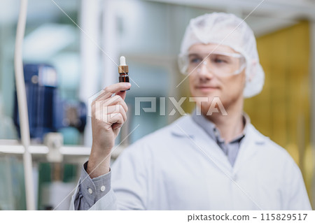 Scientist in Science Lab proudly invented New Medicine Formula. Medical factory staff happy smiling with Concentrate Medical Extract from Plant. Scientist in Science Lab proudly invented New Medicine Formula. Medical factory staff happy smiling with Concentrate Medical Extract from Plant. 115829517
