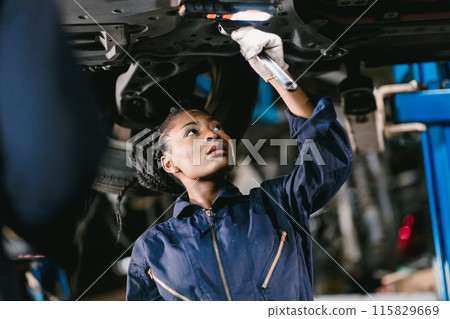 Mechanic African Women Staff Working Repair Vehicle in Car Service. Professional Worker Fix Car in Workshop Together. Mechanic African Women Staff Working Repair Vehicle in Car Service. Professional Worker Fix Car in Workshop Together. 115829669