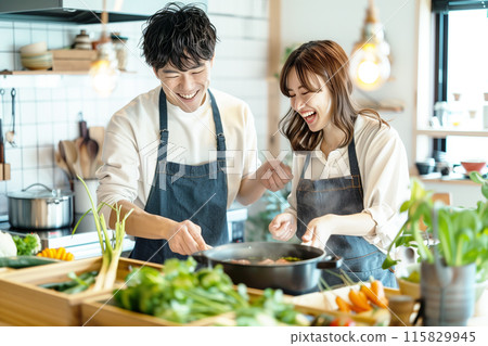 Couple cooking and doing housework in the kitchen Couple cooking and doing housework in the kitchen 115829945