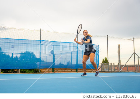 Professional female tennis player playing the tennis on outside court 115830163