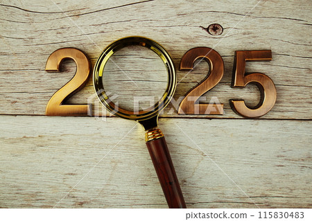 Happy New Year 2025 and magnifying glass top view on wooden background, new year goal and resolution concept background Happy New Year 2025 and magnifying glass top view on wooden background, new year goal and resolution concept background 115830483