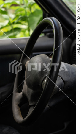 Black steering wheel and interior of the car, near Black steering wheel and interior of the car, near 115830586