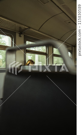 A woman rides in an old train A woman rides in an old train 115830589