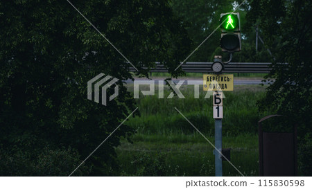 Railway, pedestrian traffic light with the sign Beware of the train Railway, pedestrian traffic light with the sign Beware of the train 115830598