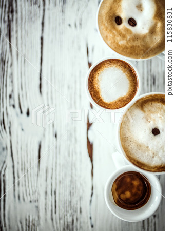 Cups with hot espresso, cappuccino, latte on table. Shot with copy space. 115830831