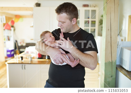 Father holding his newborn baby. Unconditional paternal love, Father's Day concept. Father holding his newborn baby. Unconditional paternal love, Father's Day concept. 115831053