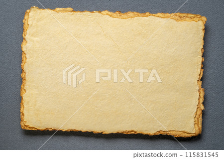 stack of tan toned heavyweight deckle edge paper sheets 115831545