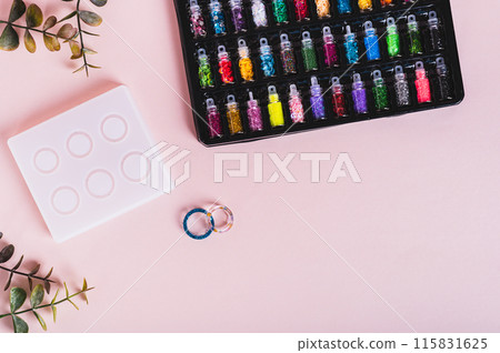 Epoxy resin rings, mold and sparkles for making on a pink background top view Epoxy resin rings, mold and sparkles for making on a pink background top view 115831625